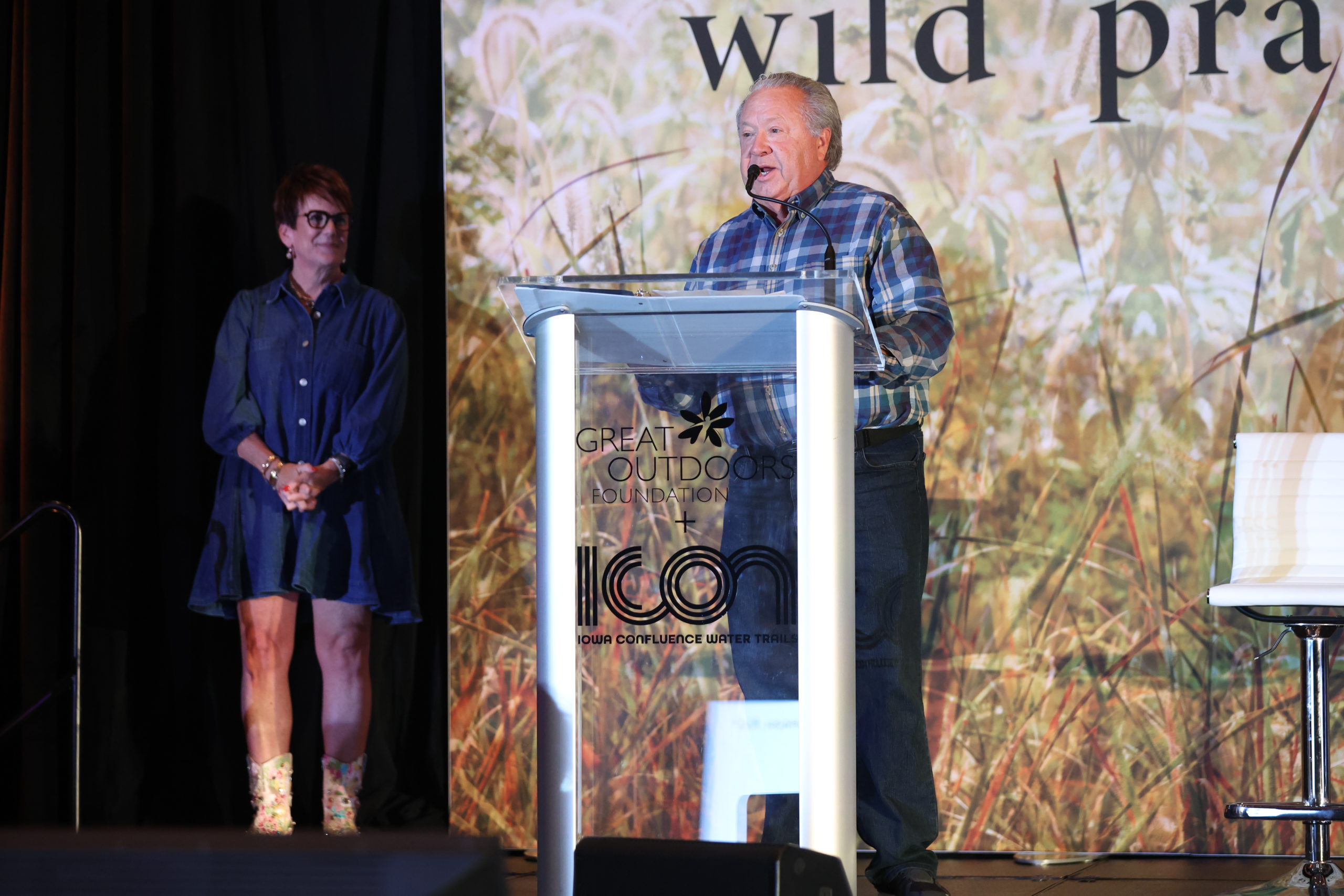 Rick Tollakson speaking in to the microphone during the awards