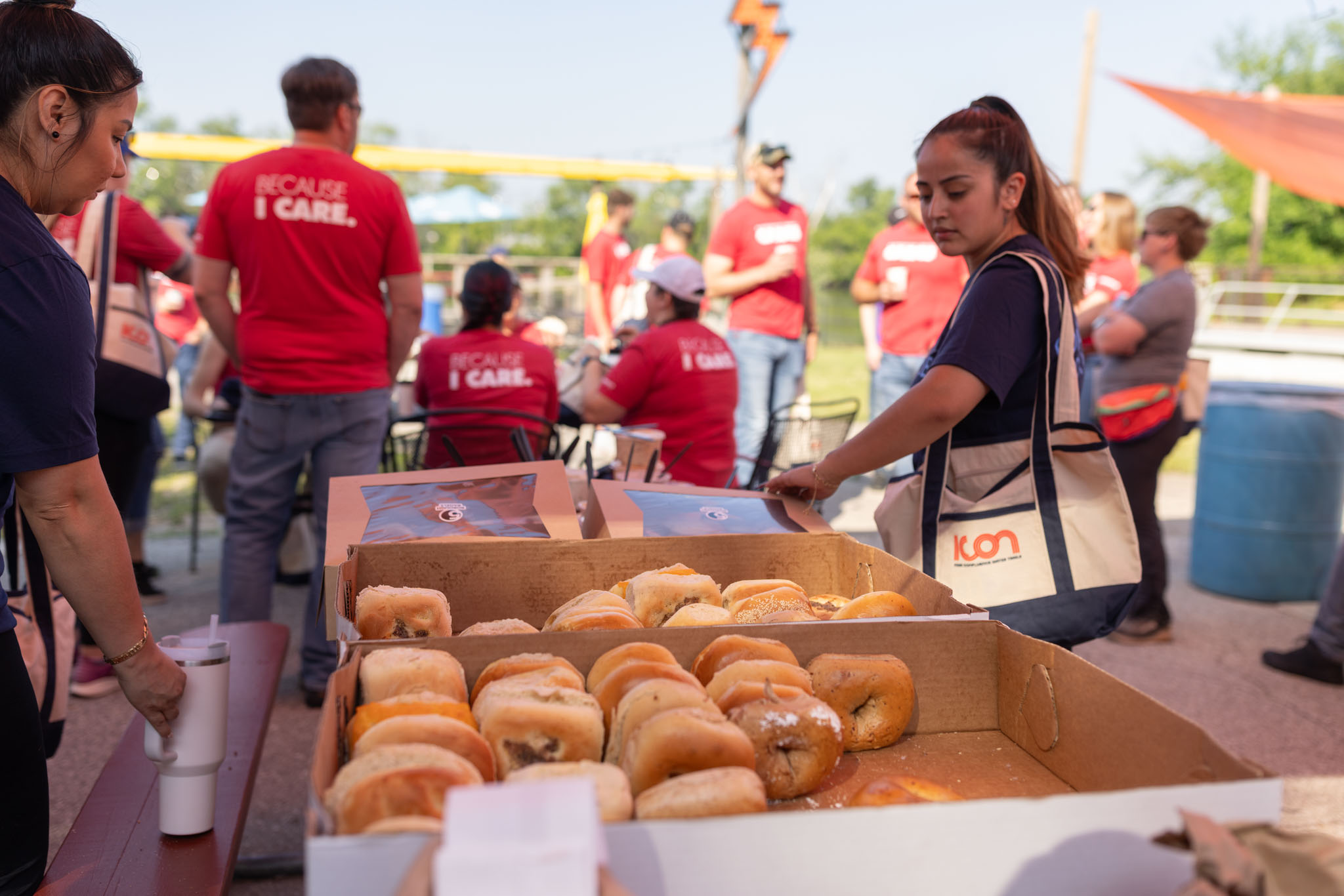 A woman with an ICON canvas bag looking at a variety of bagels being offered