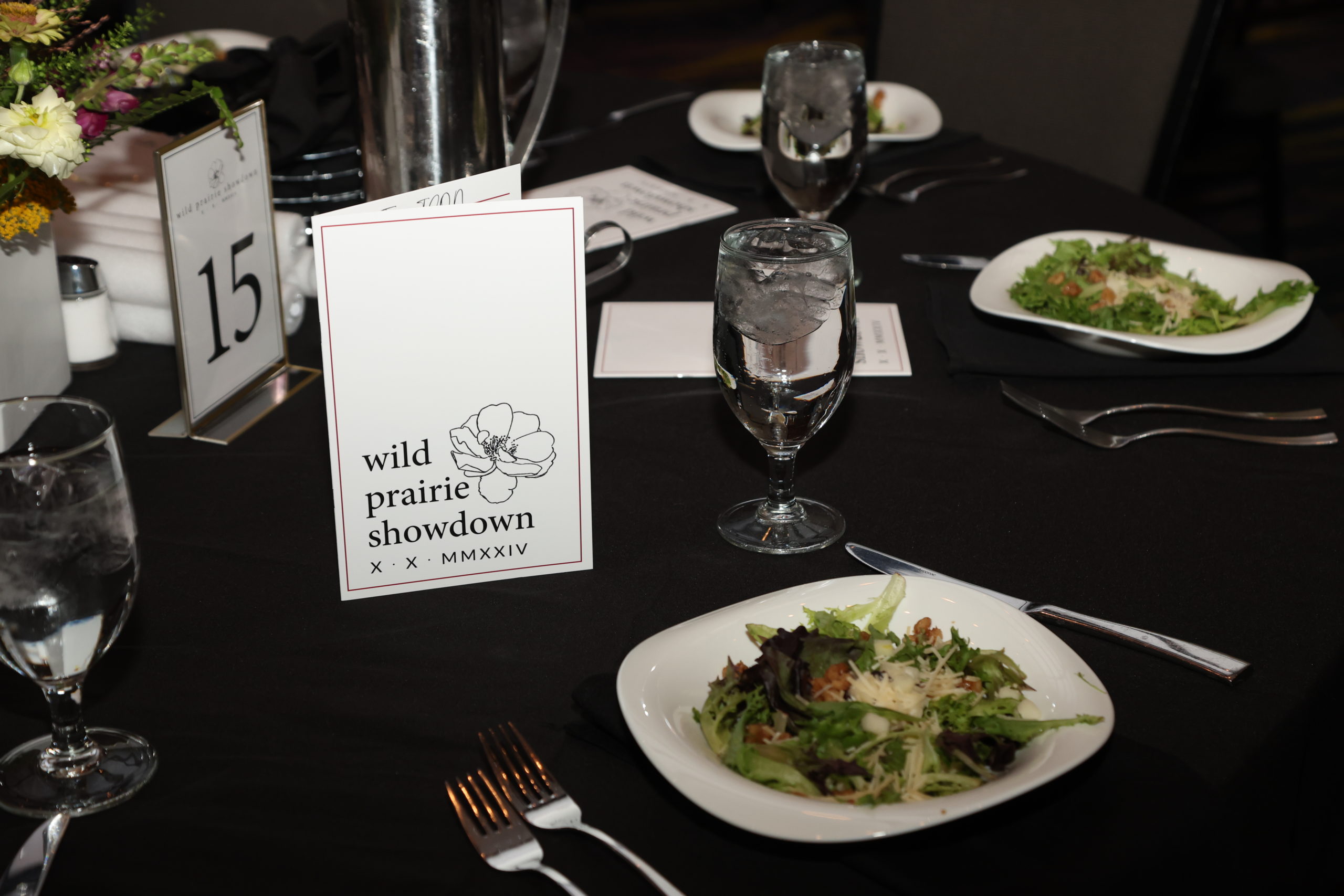 Dinner salads on a table with ice water in nice glasses