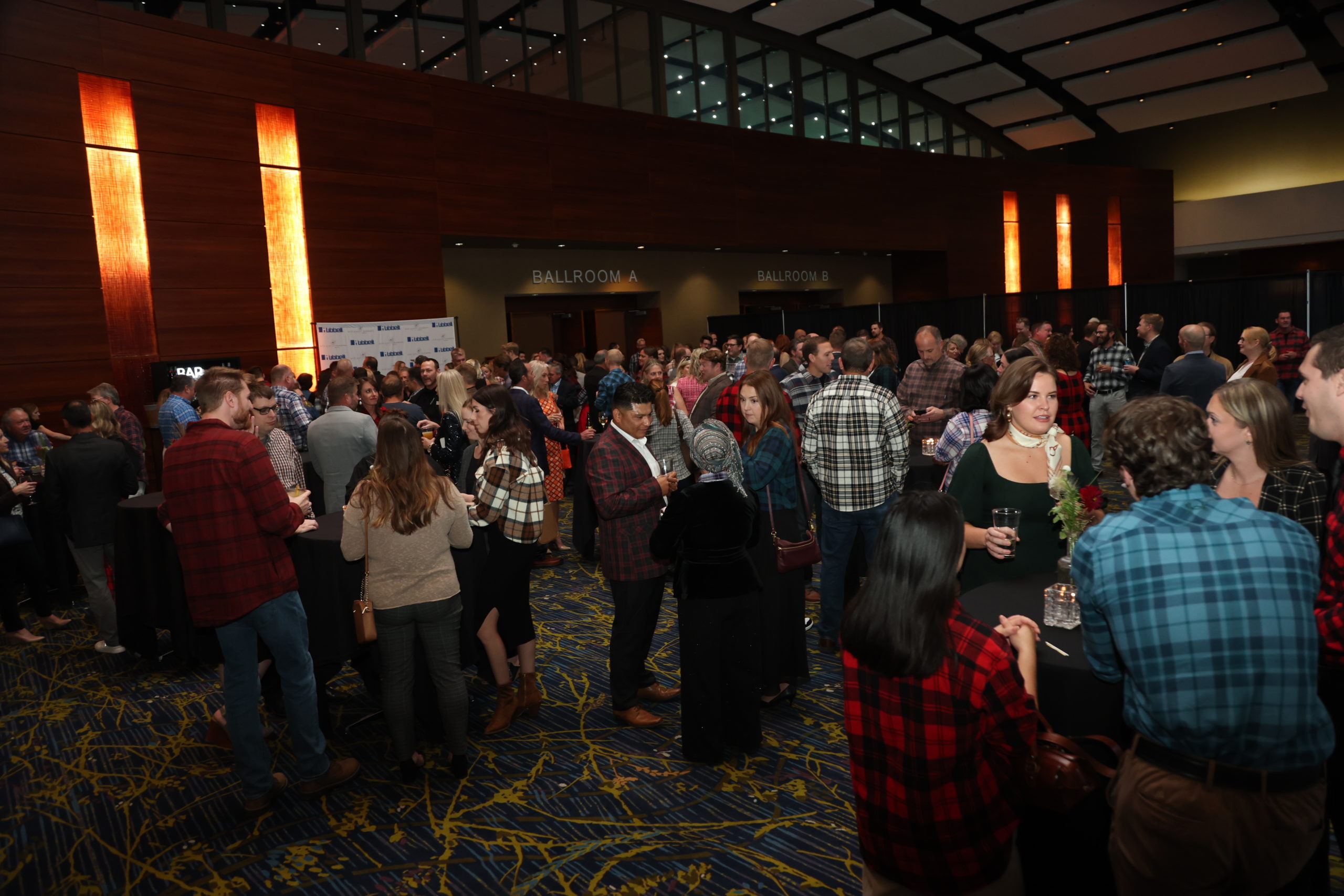 A large group of people mingling outside the event