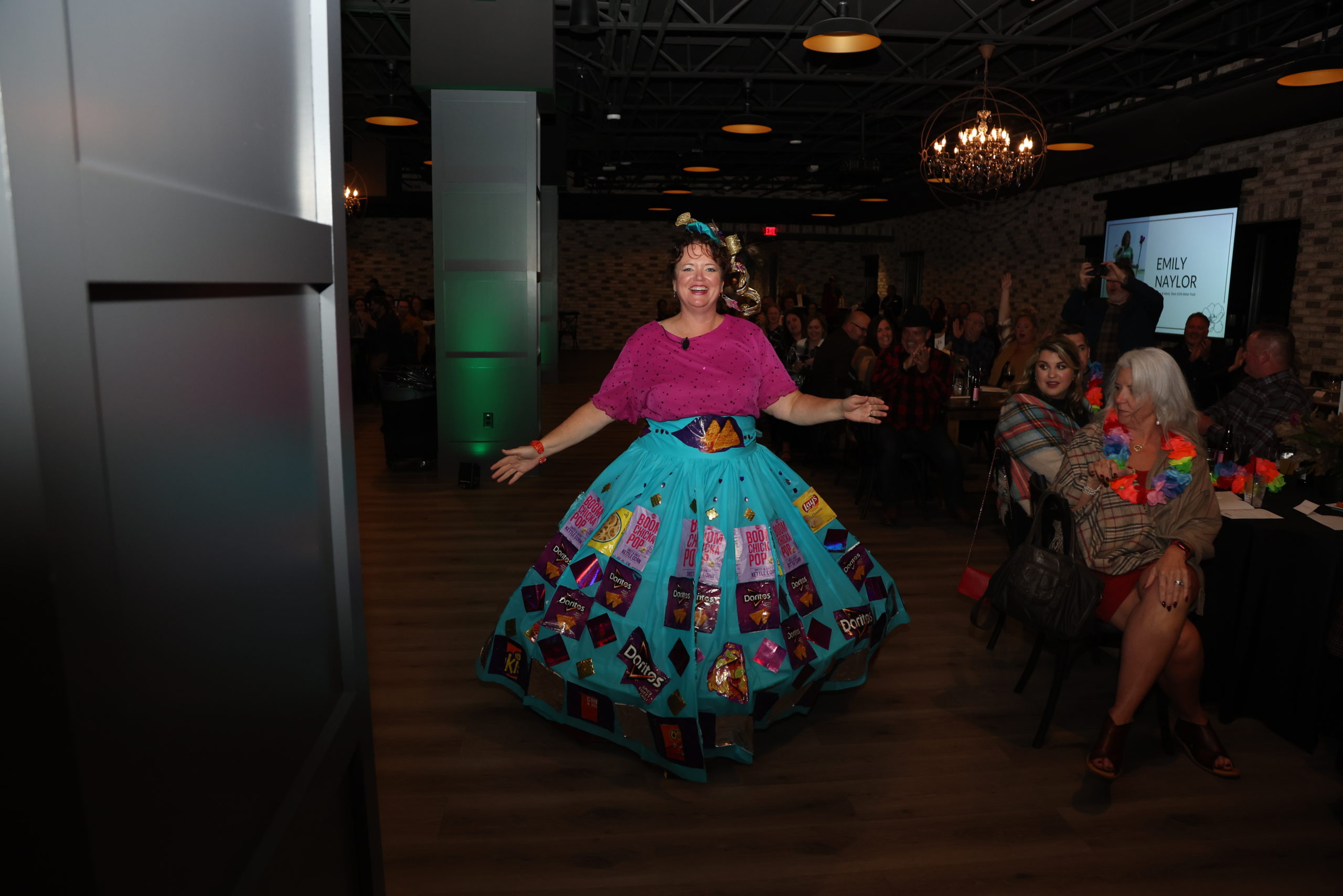 A woman wearing a skirt made of wrappers from snack foods