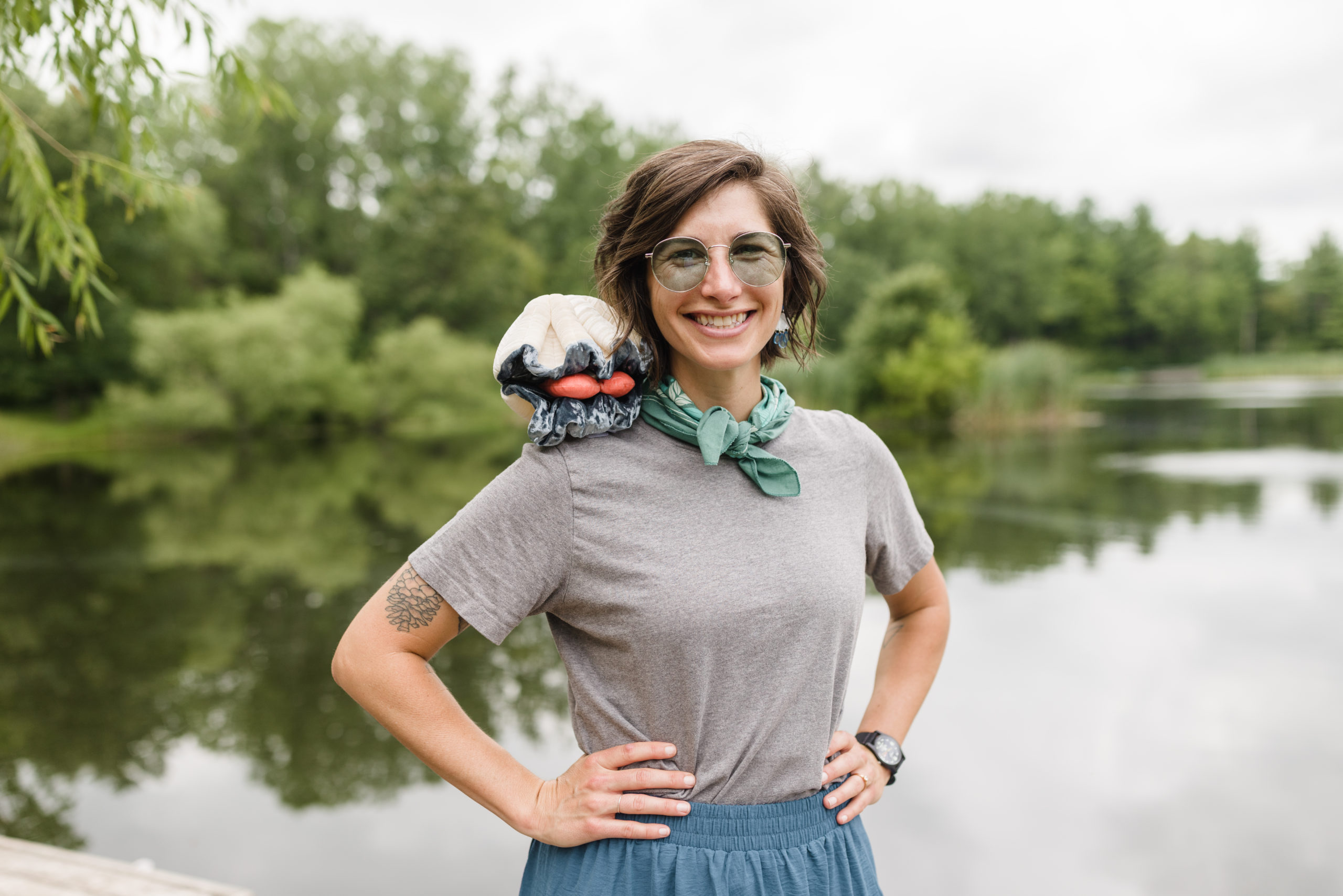 Molly "Ms. Drizzle" Hanson standing by the water with her hands on her hips