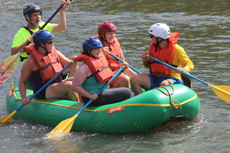 A group of 5 in a small river raft