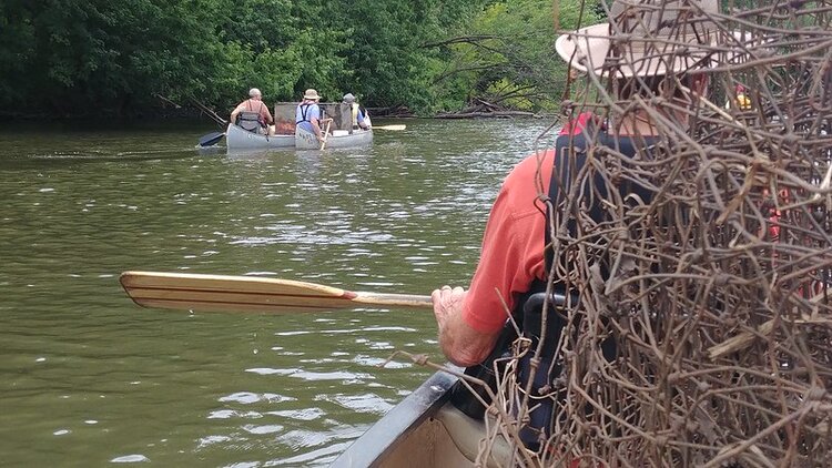 Canoes carrying a variety of metals pulled from the river