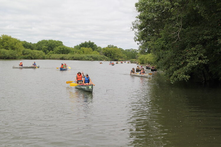 A large group of people in canoes