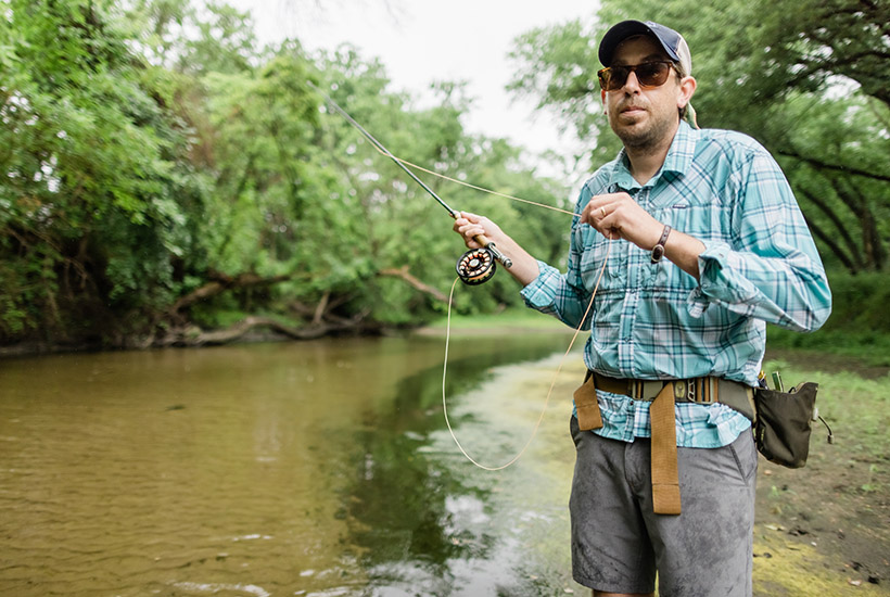 A man flyfishing in Beaver Creek. He's in the process of pulling his line