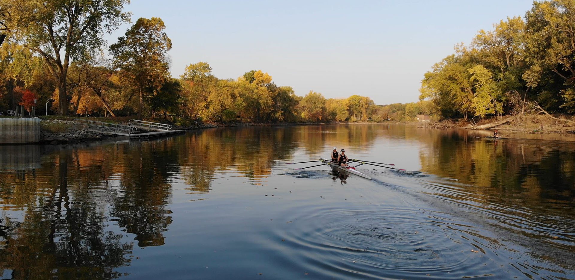 Two rowers in a boat on the river