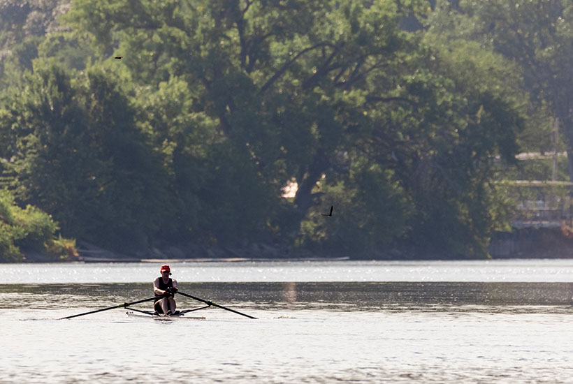 A woman rowing on the Des Moines River