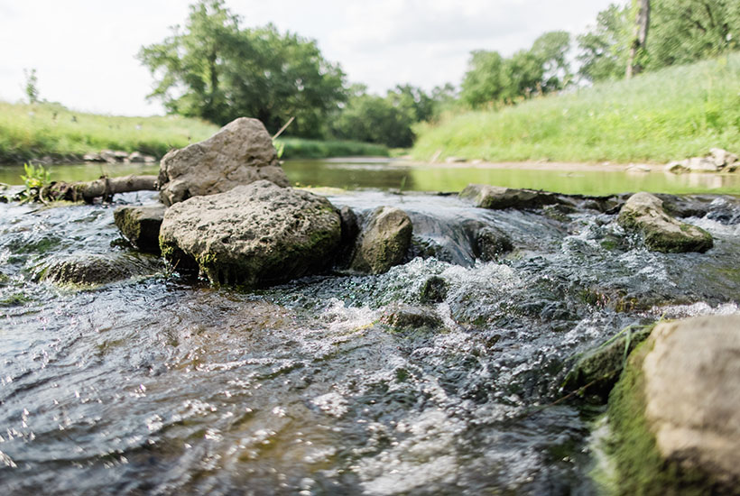 A close up view of water pouring over rocks in the Four Mile Creek