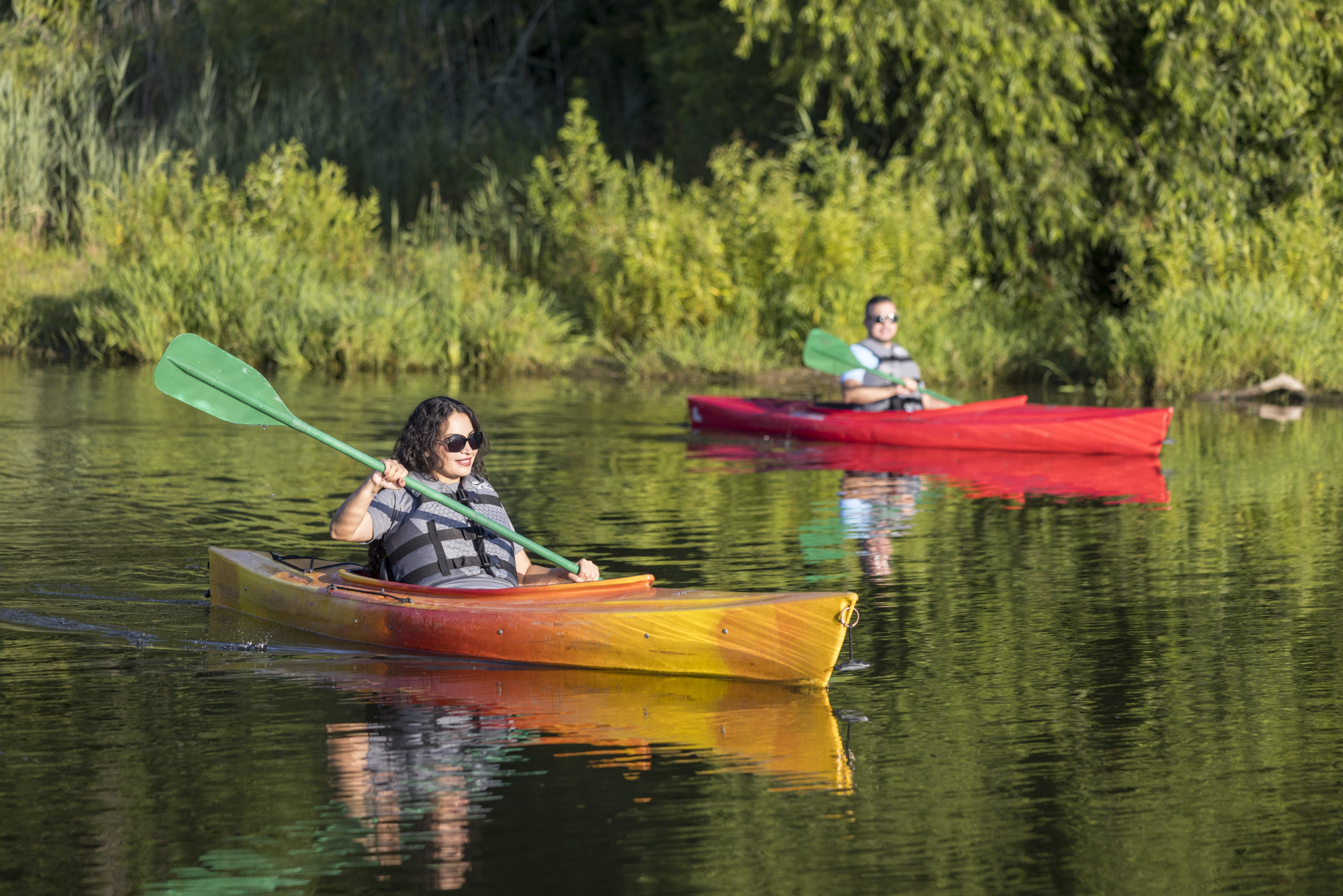 Two people kayaking on calm water