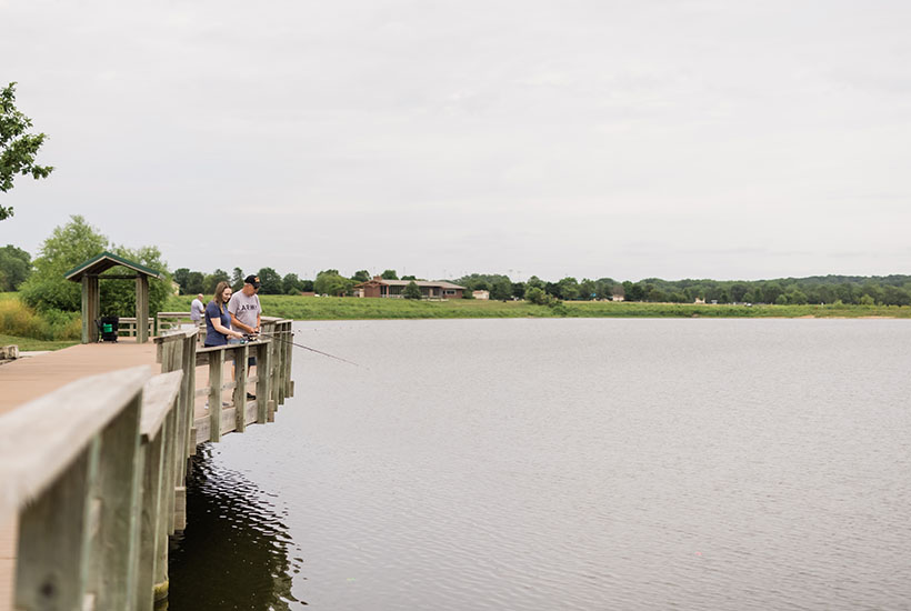 People fishing off a fishing pier that was built above the water