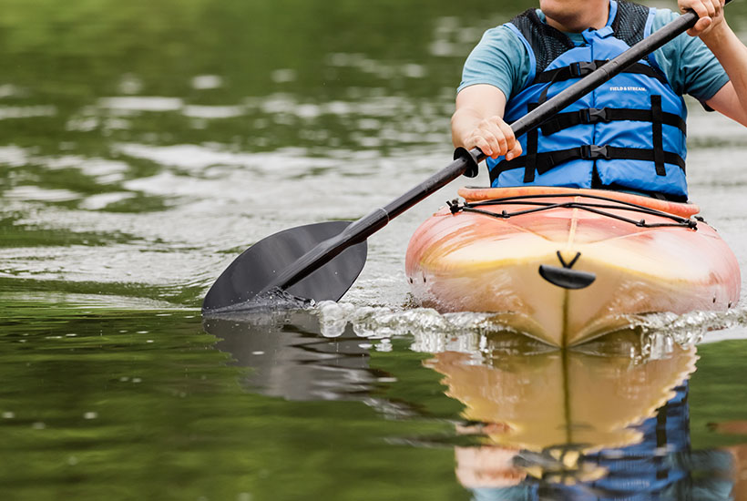 A close up view of a paddle gliding through the water