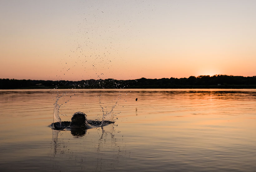 Something splashing in the water during sunset