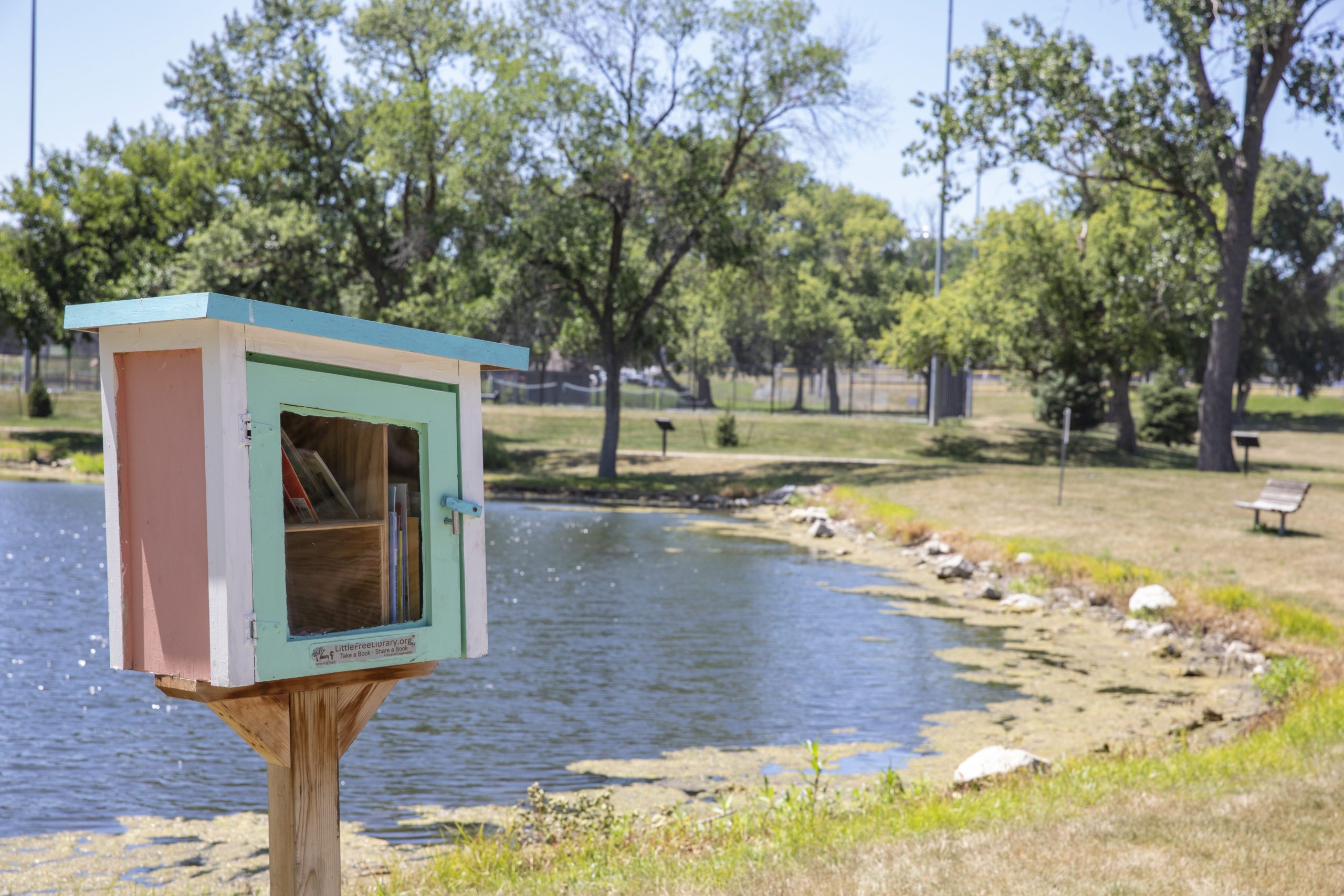 A little free library in a park near the water