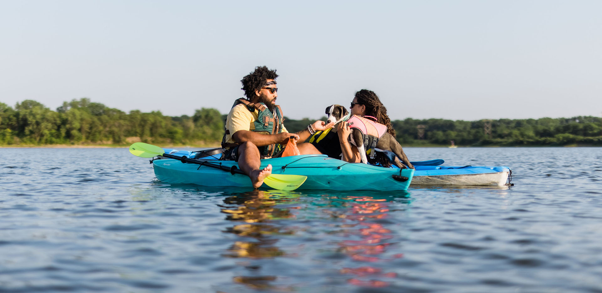 News-CapitalCampaignSurpasses200-1920×935-1 Two people sitting next to each other on kayaks in the water