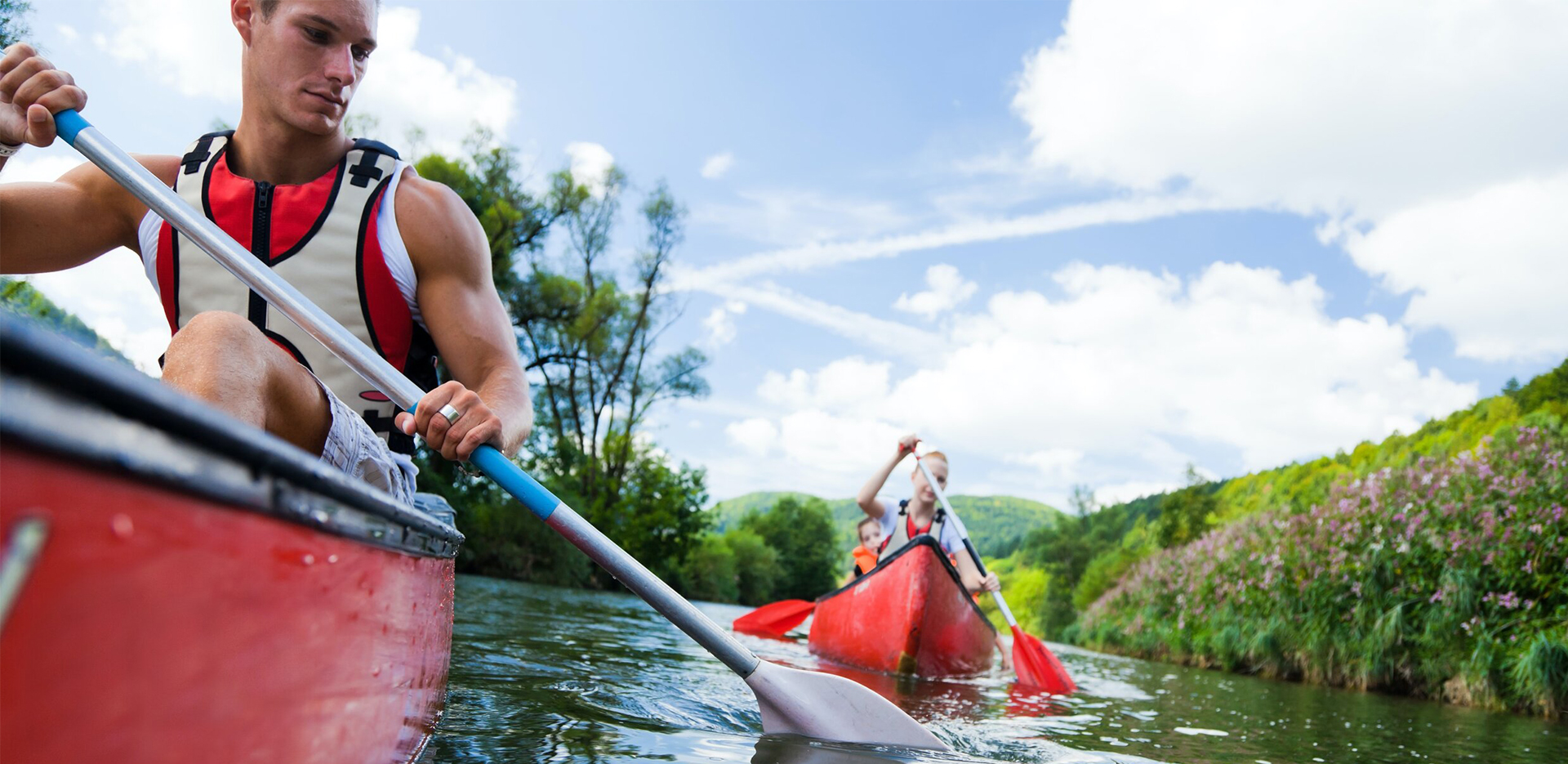 News-GreatOutdoorsFoundation-1920×935-2 A group of canoers paddling on the river